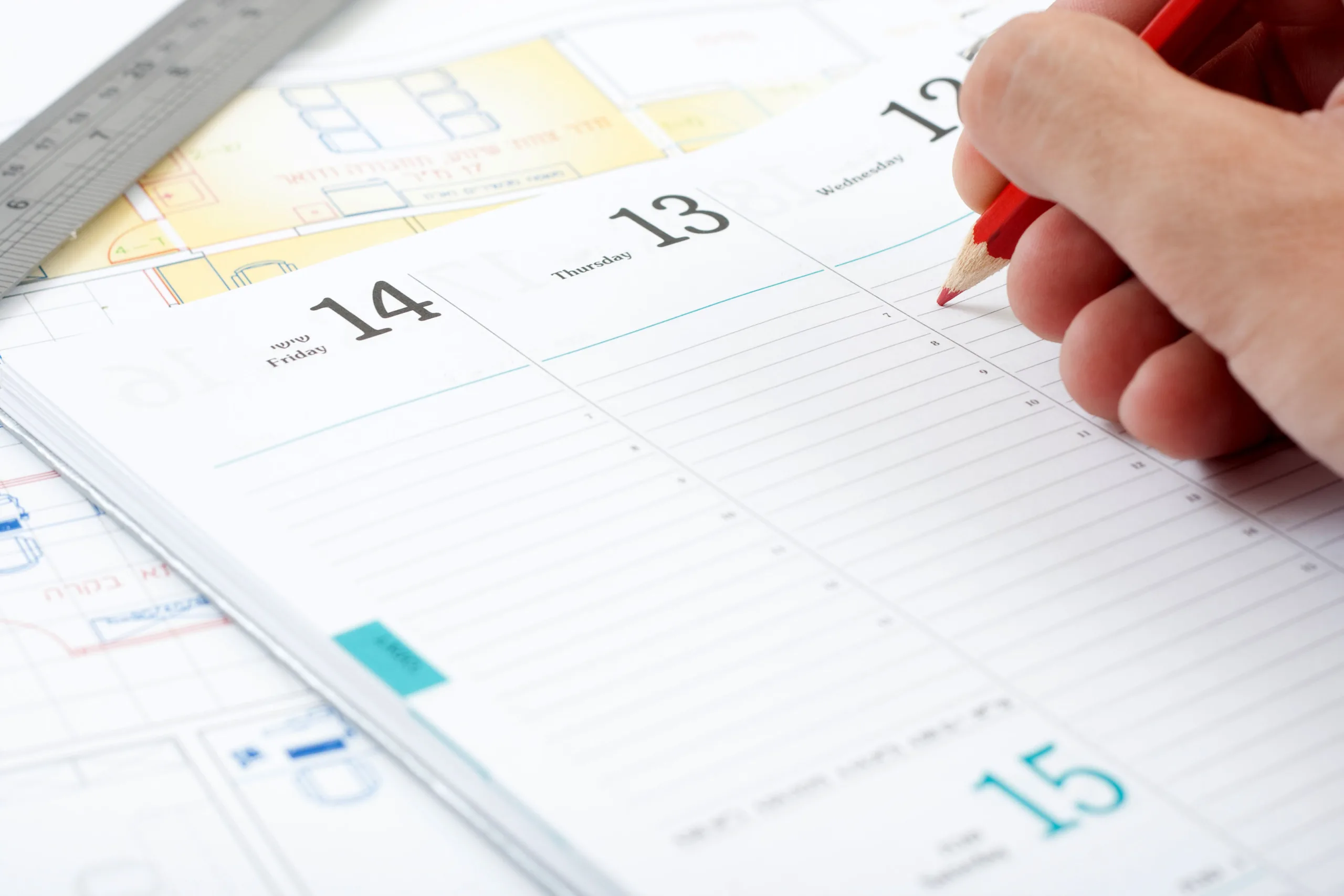 Hand writing an entry in an appointment book